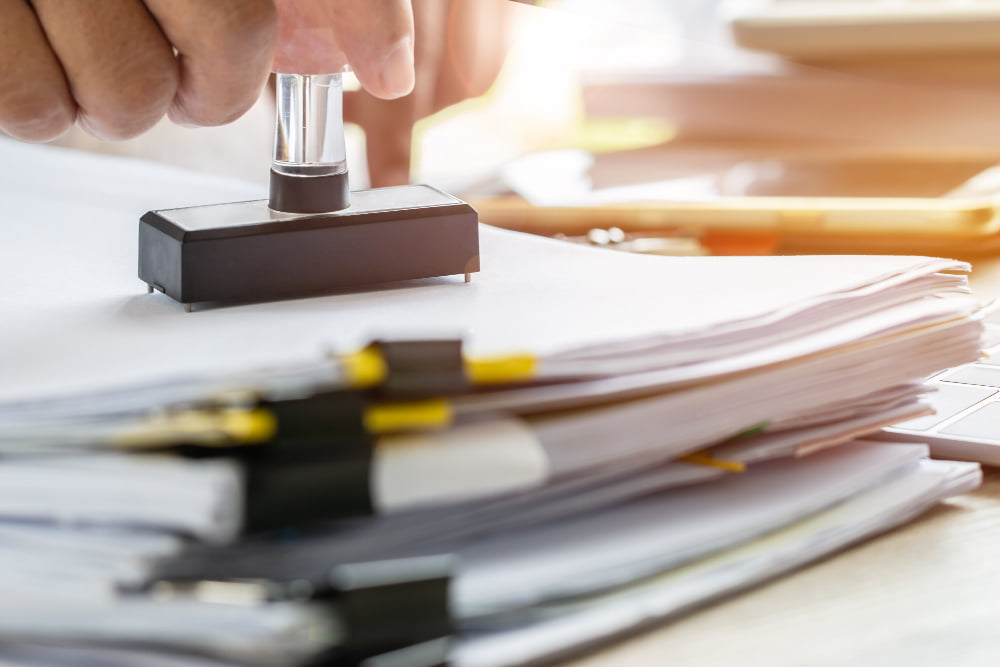 business-person-s-hand-stamping-approved-application-form-notary-public-stamping-documents IT Operation Solution - Equine Global - S/4HANA - SAP Indonesia - SAP ERP - IT Consulting - ISO 27001